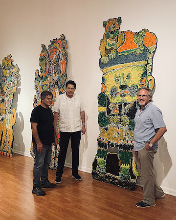 Andy Villareal next to one of his paintings