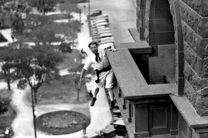 "Human fly" Babe White hanging from a balcony