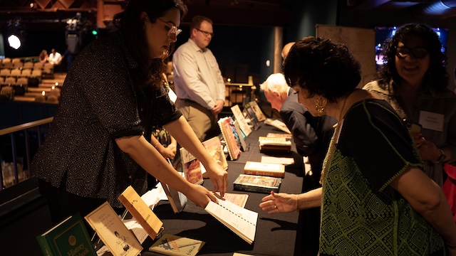 Event guests browse the cookbook collection