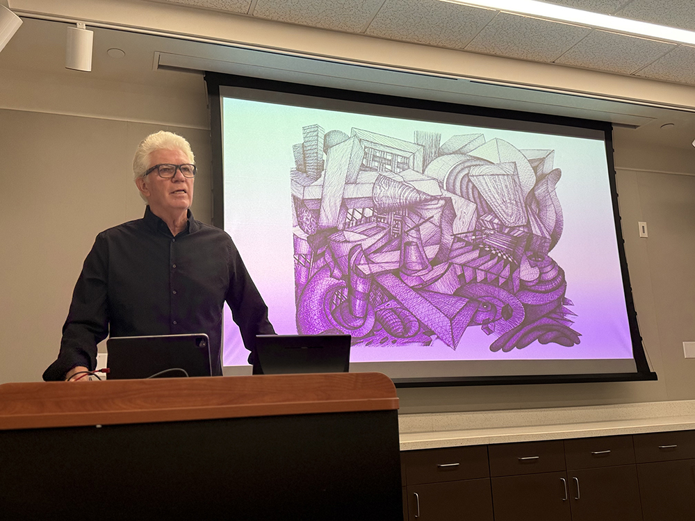 Mark Hogensen giving a presentation about the exhibition, On the Walls