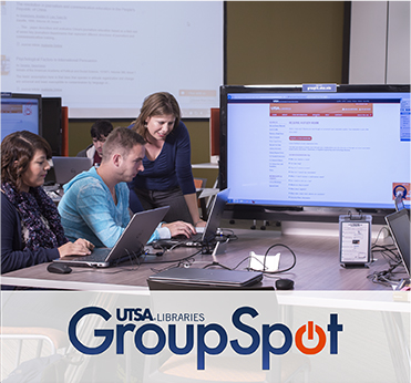 UTSA students gathered in front of a laptop computer