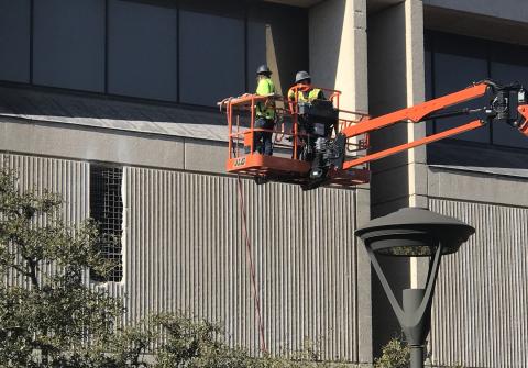 Photo of work crew removing third floor exterior concrete panels